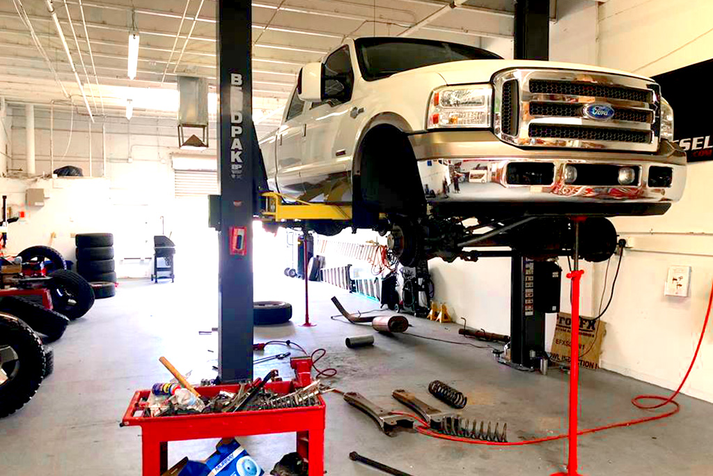 ford pickup white lift kit install progress